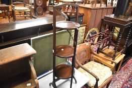 An early 20th Century mahogany folding cake stand