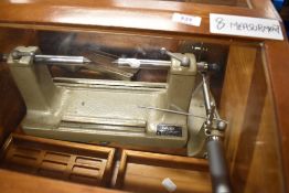 A vintage Matrix diameter measuring machine, in stained frame and glazed case