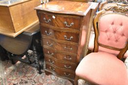 A reproduction Regency narrow serpentine chest of six drawers