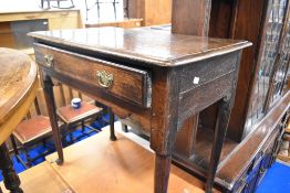 A Georgian oak side table having single frieze drawer over shaped apron