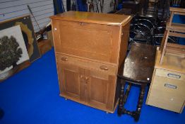 A vintage golden oak Ercol or similar bureau