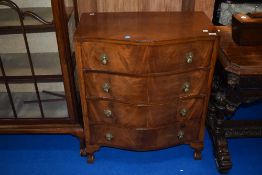 A mid 20th Century reproduction bow front chest of four drawers