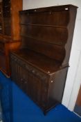 A vintage priory style oak dresser