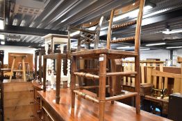 A 19th Cetury oak framed bobbin back kitchen chair with rush seat and a later cane seated carver