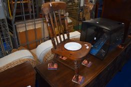 A traditional stained frame child's commode chair with enamel dish