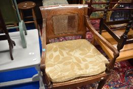 A 19th Century mahogany framed armchair having bergere back and seat , with fluted frame, some