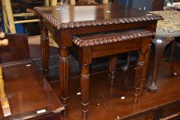 A modern mahogany nest of two occasional tables
