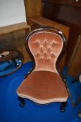 A Victorian mahogany framed nursing chair having later button back upholstery
