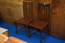 A pair of early 20th Century stained frame dining chairs