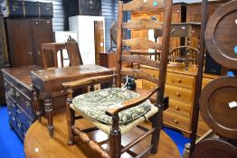 A 19th Century ladder back carver chair having strung seat