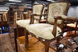 A pair of reproduction Continental style armchairs with tapestry style upholstery
