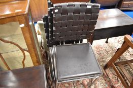A set of four leather and chrome dining chairs