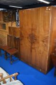 A 1930s design walnut two piece bedroom suite comprising bedroom and tallboy