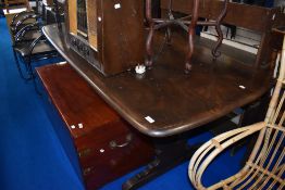 A dark stained Ercol refectory style dining table