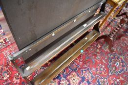 A dark stained Ercol wall shelf