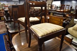 A set of six 19th Century mahogany rail back dining chairs and a similar scroll end carver chair