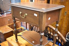 A vintage oak side table with drawer and undershelf