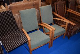 A pair of Arts and Crafts golden oak armchairs