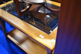 A modern golden oak and glass coffee table