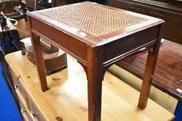 A vintage stained frame stool with canework seat