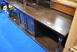 A vintage dark oak coffee table with cupboard storage under