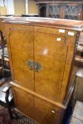 A vintage walnut cocktail cabinet