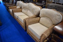 A modern wicket three piece lounge/conservatory suite