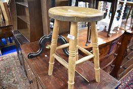 A traditional stool having turned frame