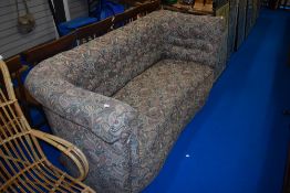 An early 20th Century Knowle style settee having shaped frame in paisley upholstery