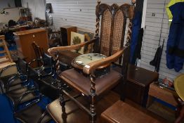 An early 20th Century oak carver chair having twist frame and cane back