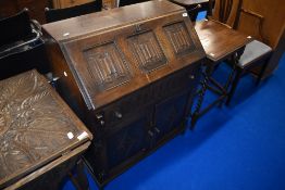 An early to mid 20th Century oak bureau having linen fold decoration