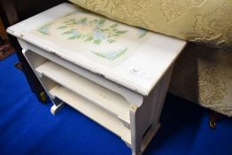A vintage painted Arts and Crafts style occasional table with shelves under