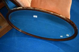 An early 20th Century mahogany oval wall mirror