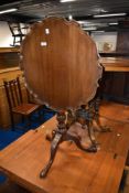 A late 19th or early 20th Century mahogany snap top table on turned column and triple splay legs