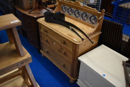 A Victorian pine wash stand having tiled back