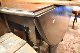 A mid 20th Century oak gate leg dining table