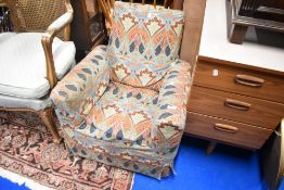 A vintage child's armchair having William Morris style loose cover