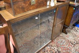 A vintage dark oak bookcase with cupboard to side