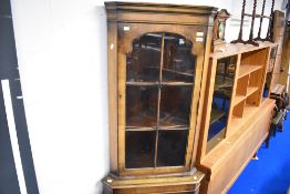 A reproduction mangoany/walnut corner display with cupboard under