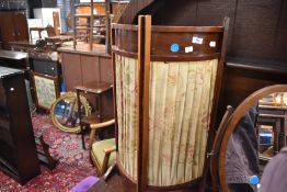 A traditional mahogany folding fire or small modesty screen