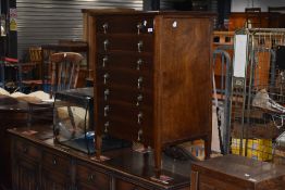 An early 20th Century mahogany seven drawer music cabinet