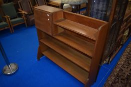 An Arts and Crafts golden oak bookshelf with bureau section, in the Arthur Simpson style with