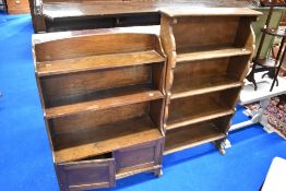 Two traditional dark oak bookshelves , one having cupboard to base