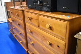 Two red stain pine bedroom chests of two over three drawers and a similar bedside set of two