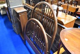 An early 20th Century oak single bed frame with sprung base