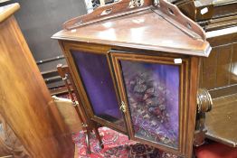 An Edwardian mahogany and inlaid corner display on tapered legs with spade feet