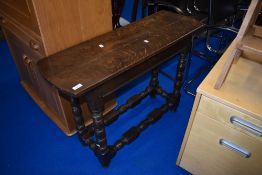 A period oak side table of narrow proportions on turned frame