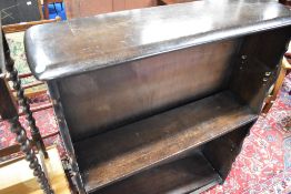 A dark stained Ercol style bookshelf