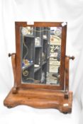 A Victorian mahogany swing mirror.