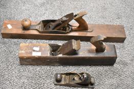 Two vintage Jack planes and a smaller Stanley plane.